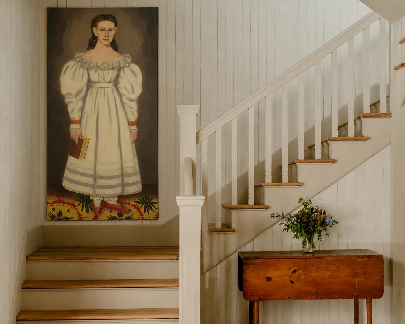 Portrait beside a white staircase in a traditional home interior