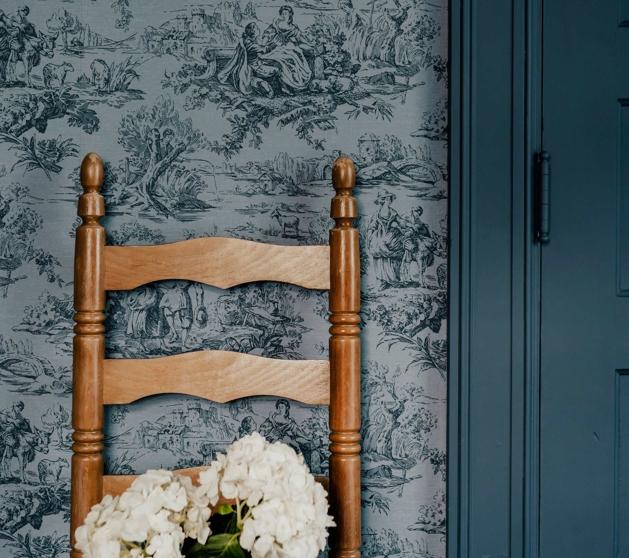 room with wallpaper, blue door