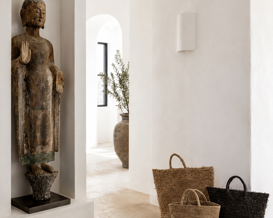 An intentional residential entrance foyer featuring a quiet arched threshold and woven woven baskets, illustrating how personal birth element calculations align with house layout optimization and spatial flow.